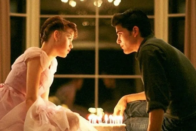 Molly Ringwald and Michael Schoeffling as Sam and Jake in birthday cake scene from Sixteen Candles, rom com from the 80s