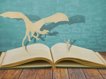 Hero with a sword and a dragon on the pages of a book